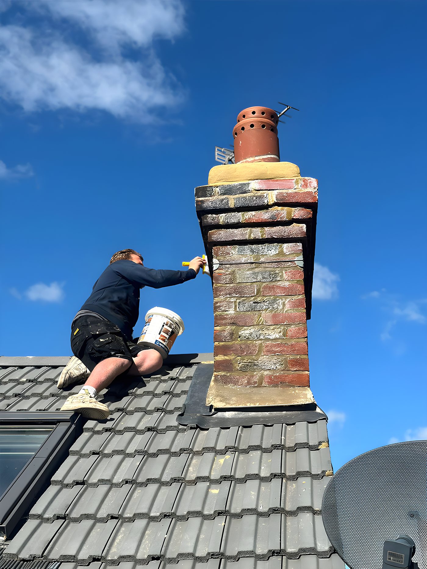 One of our roofers repointing a chimney stack