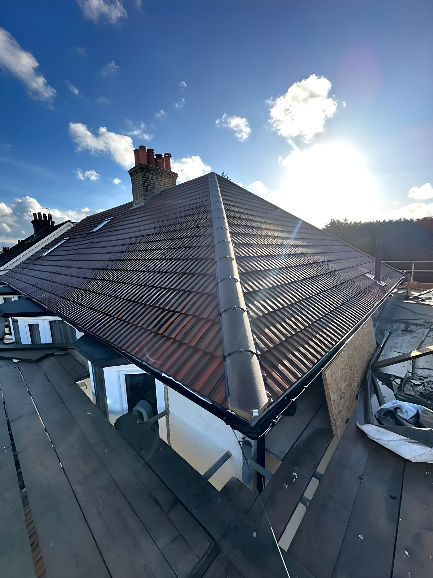 A hipped roof re-tiled in brown concrete tile