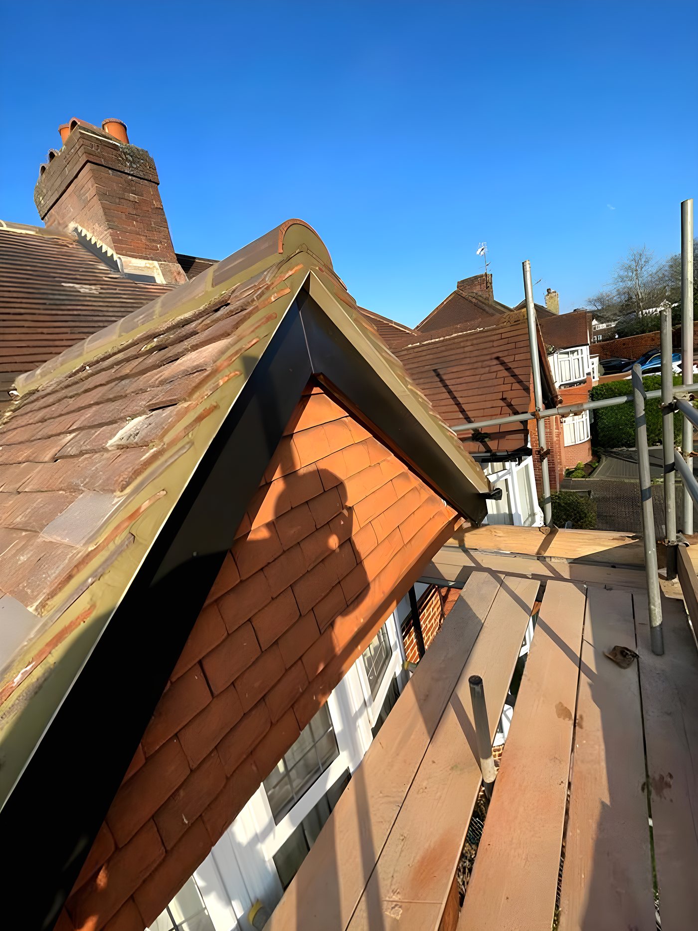 A repair at a gable, done from the roof rather than guessed at