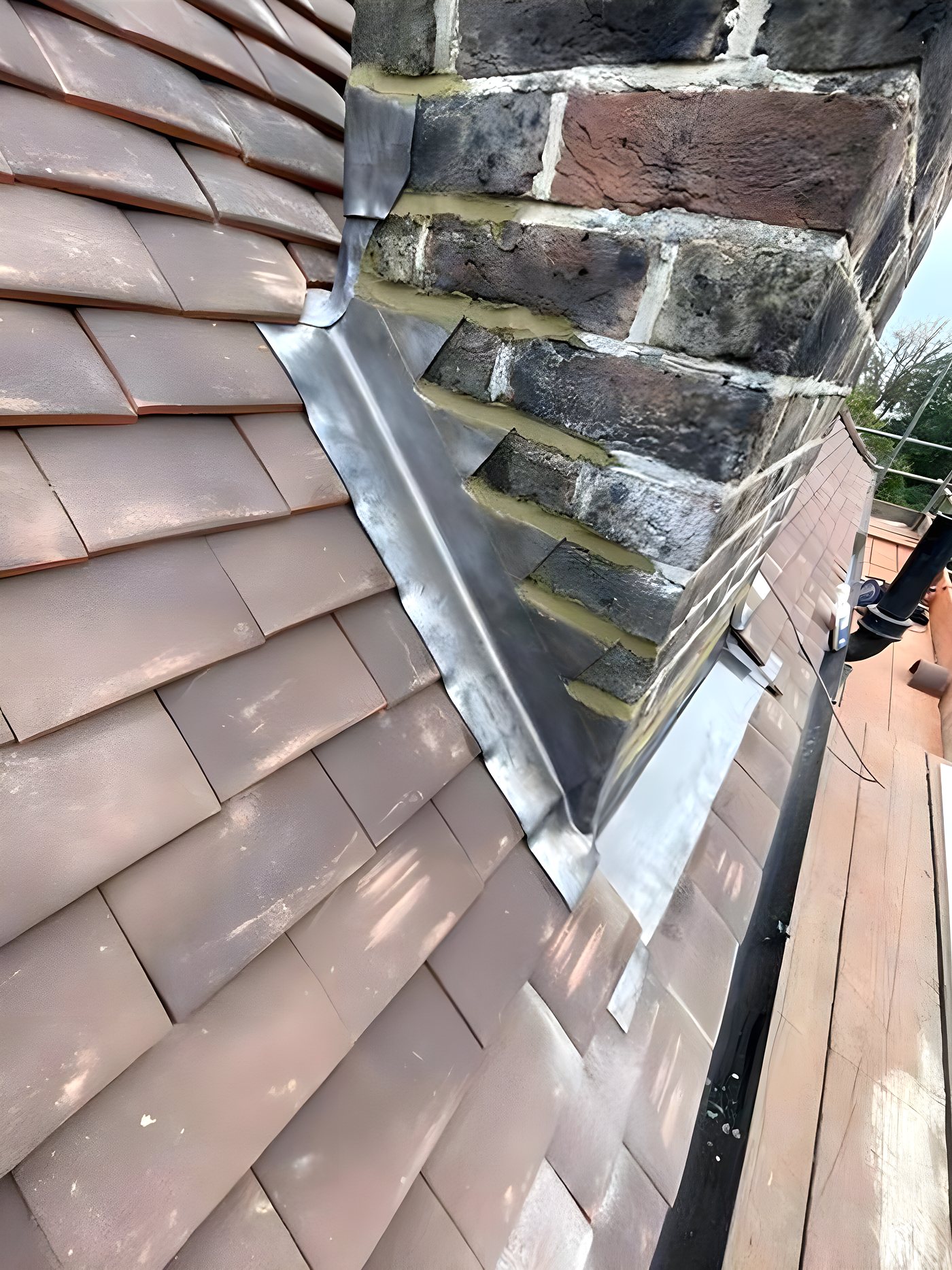 Step flashing dressed into a chimney stack