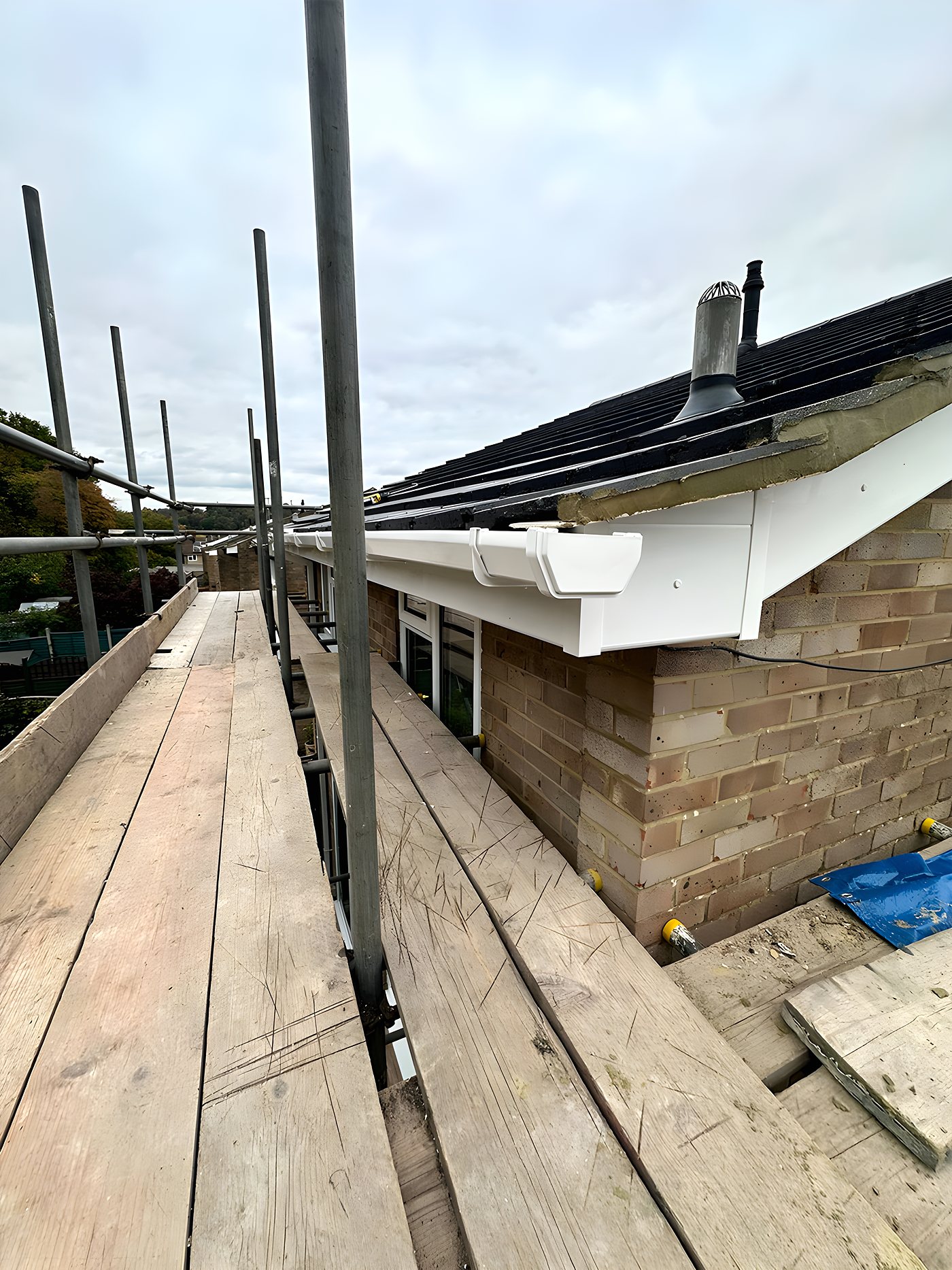 Scaffold boards along the eaves for a fascia and gutter run